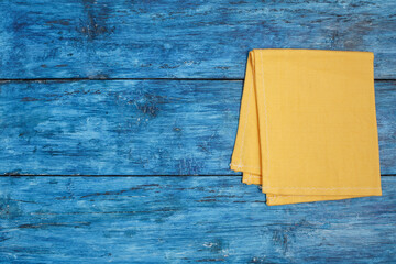 Wall Mural - Yellow napkin on blue boho table