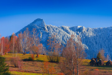 Wall Mural - Mountain lanscape in november. Late autumn scene with snow on Ceahlau mountain, Romania