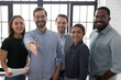 © fizkes - Happy millennial business group leader giving hand for shake. Photo Portrait of diverse professional team welcoming employees for hire and job. Lawyers or brokers offer deal to clients and customers