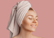 © Daria Lukoiko - Beautiful sensual young girl with clean skin on a pink background with a mockup. Topless woman in a towel. The concept of spa treatments, natural beauty and care, youth, cream and mask, freshness