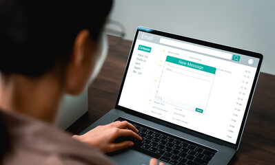 Woman using computer on table with new email message on laptop, communication connection message to global letters in the workplace.