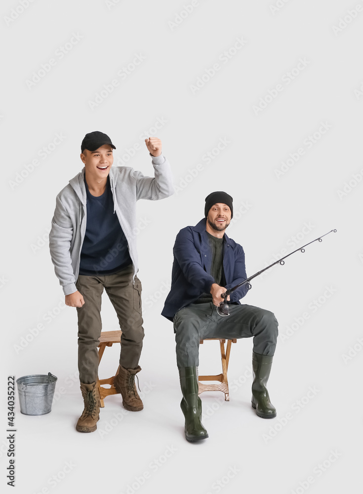 Happy father and son fishing on white background