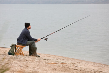 Poster - Man fishing on river bank