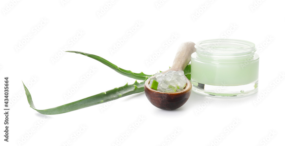 Jar with natural cream and spoon with aloe on white background