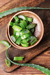 © Pixel-Shot - Plates with fresh cut aloe on wooden background