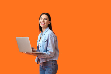Young woman with laptop on color background