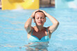 © H_Ko - Portrait of young woman in pool with closed eyes