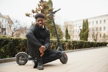 Active Leisure Concept. Side View Of Black Male Student Driving Stand-up Scooter Over Brick Road, Copy Space For Ad Or Text