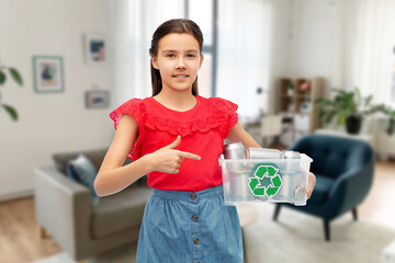 Wall Mural - metal recycling, waste sorting and sustainability concept - smiling girl holding plastic box with tin cans over home room background