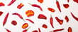 Peppers and tomatoes banner background. Dried hot chili peppers and red sun-dried tomatoes on a white plate. Spices and vegetables food minimal flat lay background concept