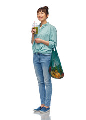 Sticker - healthy eating and sustainability concept - asian woman drinking green smoothie from plastic cup and holding reusable string bag with fruits and vegetables over white background