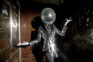 mr disco ball dancing in a lift