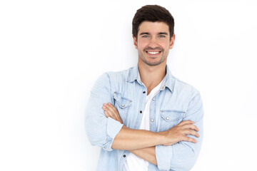 Сlose-up shot handsome self-assured cheerful male businessman has a wide smile crossed arms while wearing a fashionable denim shirt