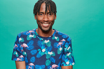 Young Black Wearing a printed t-shirt Over A Turquoise Background