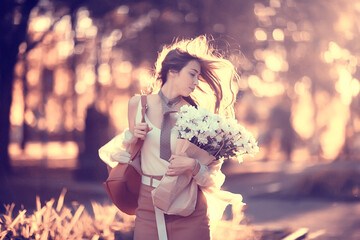 Wall Mural - girl holding a bouquet of flowers a walk in the park / romantic young beautiful cute model, love fee