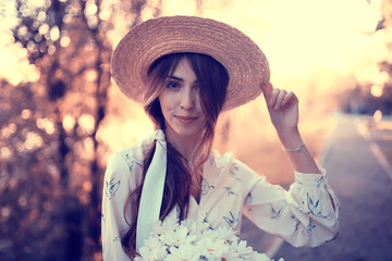Wall Mural - happy romantic girl in a straw hat / young model in a dress summer day, happiness woman
