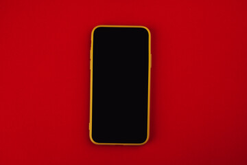 Smartphone on red background with copy space