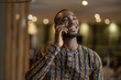 © JonoErasmus - Black African business entrepreneur smiling conversation on phone