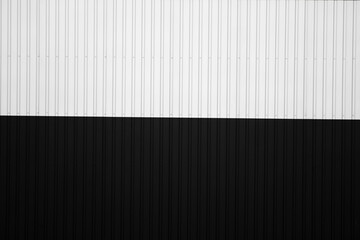 Wall Mural - Black and white corrugated iron sheet used as a facade of a warehouse or factory. Texture of a seamless corrugated zinc sheet metal aluminum facade. Architecture. Metal texture.