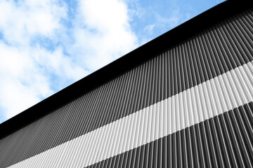 Wall Mural - Black and white corrugated iron sheet used as a facade of a warehouse or factory. Texture of a seamless corrugated zinc sheet metal aluminum facade. Architecture. Metal texture.