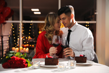 Wall Mural - Lovely couple having romantic dinner on Valentine's day in restaurant