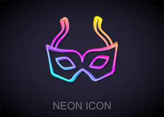 Sticker - Glowing neon line Festive mask icon isolated on black background. Merry Christmas and Happy New Year. Vector