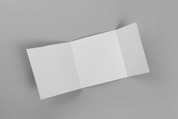 Blank paper brochure on light grey background, top view. Mockup for design