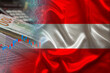 national flag of Austria on satin, dollar bills, computer, concept of global trading on the stock exchange, falling and rising prices for world currency
