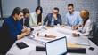 © BullRun - Confident business partners spending daytime for collaborate in office discussing blueprints and design project, successful male and female colleagues talking about trade exchange and sketches