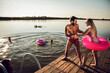 © Zoran Zeremski - Friends having fun enjoying a summer day swimming and jumping at the lake.