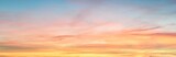 Fototapeta Zachód słońca - Clear blue sky. glowing pink and golden cirrus and cumulus clouds after storm, soft sunlight. Dramatic sunset cloudscape. Meteorology, heaven, peace, graphic resources, picturesque panoramic scenery