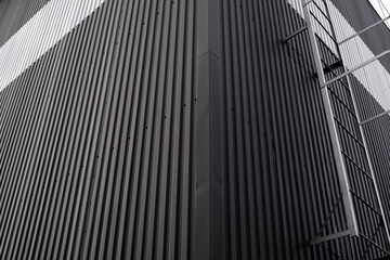 Wall Mural - Black and white corrugated iron sheet used as a facade of a warehouse or factory. Texture of a seamless corrugated zinc sheet metal aluminum facade. Architecture. Metal texture.