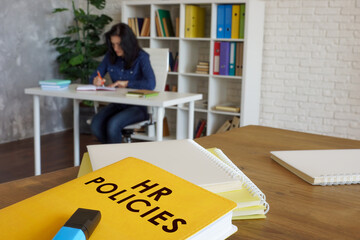 Wall Mural - HR policies guide book on desk near employee.