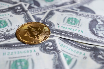 Wall Mural - closeup of  bitcoin cryptocurrency coins on US dollar bills. electronic money concept.