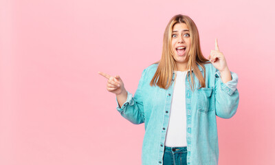 curvy pretty blonde woman feeling like a happy and excited genius after realizing an idea