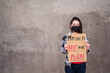 © Juan Alberto Ruiz/ADDICTIVE STOCK - Ethnic female in protective mask standing with My Life Is Not Your Porn carton poster during protect against sexual harassment and assault