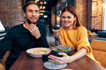 happy man and woman in cafe fun friends food