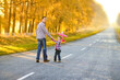© Kostia - A Happy parent walks along the road with a child and an airplane in the park on nature travel