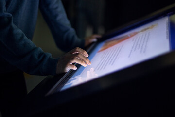 digital touch screen and hands close up, finger on large touch screen.  Interactive screens for teaching, education, receiving the information.