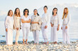 © annanahabed - Group portrait of beautiful women posing outside with beautiful mountain landscape on background, wearing white clothes