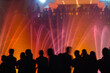 © pilat666 - People looking at fountain musical performance at night against casino. C