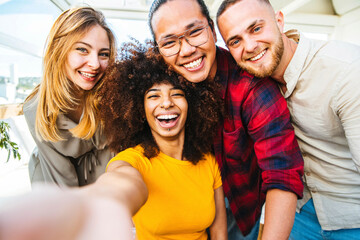 Wall Mural - Multicultural group of friends taking a selfie with african woman in foreground - Friendship concept with young people smiling at camera - Focus on black girl