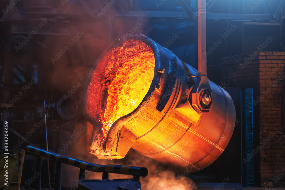 Big ladle container with molten liquid metal or iron in foundry close up. - obrazy, fototapety, plakaty 