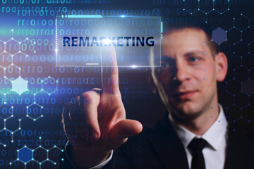 Business, Technology, Internet and network concept. Young businessman working on a virtual screen of the future and sees the inscription: Remarketing