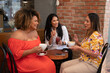 © Carlos - group of friends sitting in cafe