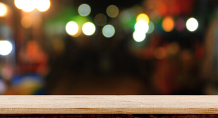 Empty wood table night street with bokeh background.