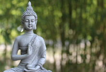 Buddha Statue In Outdoor Garden With Blurred Background