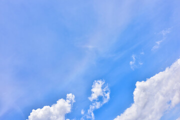 Hazy small cirrostratus, cirrocumulus and cumulus cloud formations on a sunny afternoon in late summer are contrasted against the blue sky.