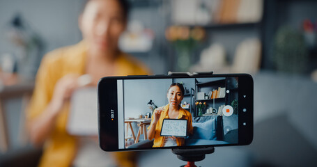 Young Asia lady teacher video call on smartphone talk by webcam learn teach in online chat at home. Remote school class, Social distancing, quarantine for corona virus prevention. Close up screen.