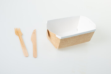 Wall Mural - cardboard brown carton box food to take away from snack fast food with wooden fork and knife